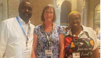 Clinton Sealy and Deirdra Johns from Black Voices Cornwall stand with Ben from CocoBean Cornwall at the HfC/BVC Windrush Celebration 2025