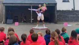 Dancers from The Place perform a circus ballet routine to children in their school playground