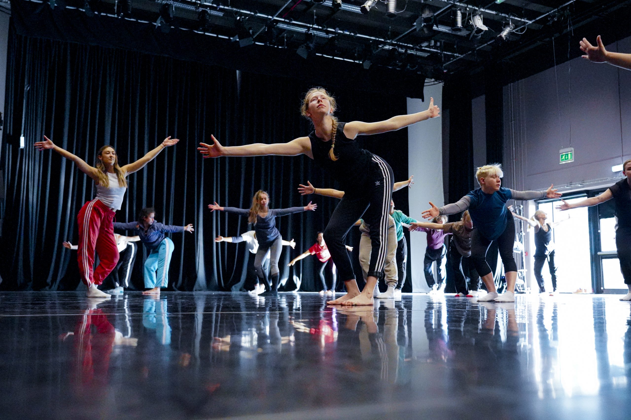 Professional dancers in a workshop - arms outstretched, learning some choreography